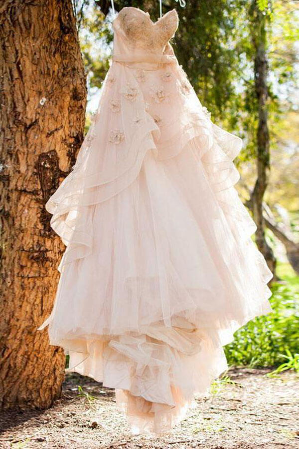 White wedding dress shop with pink flowers